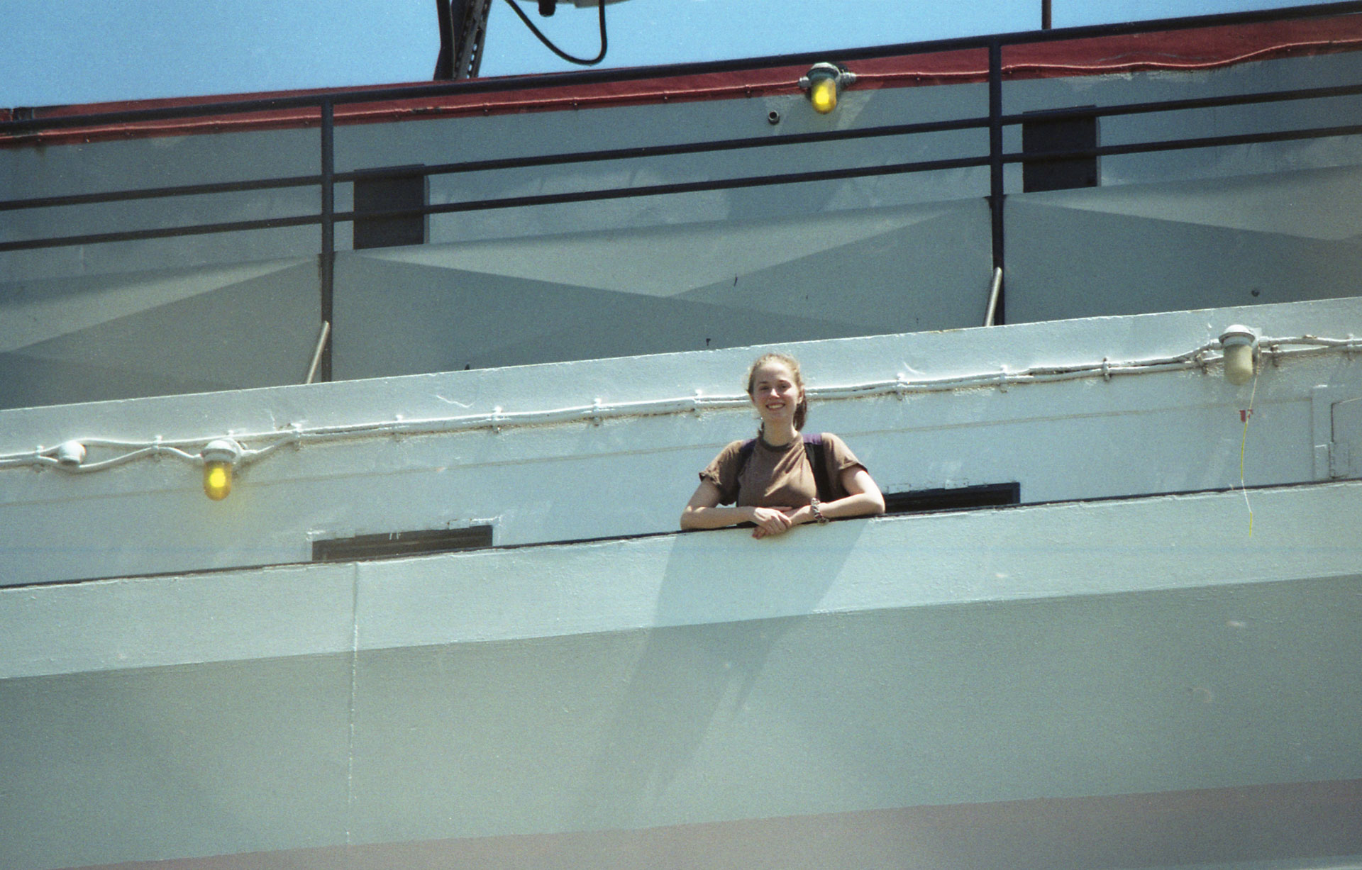 someone waving from the deck of a ship